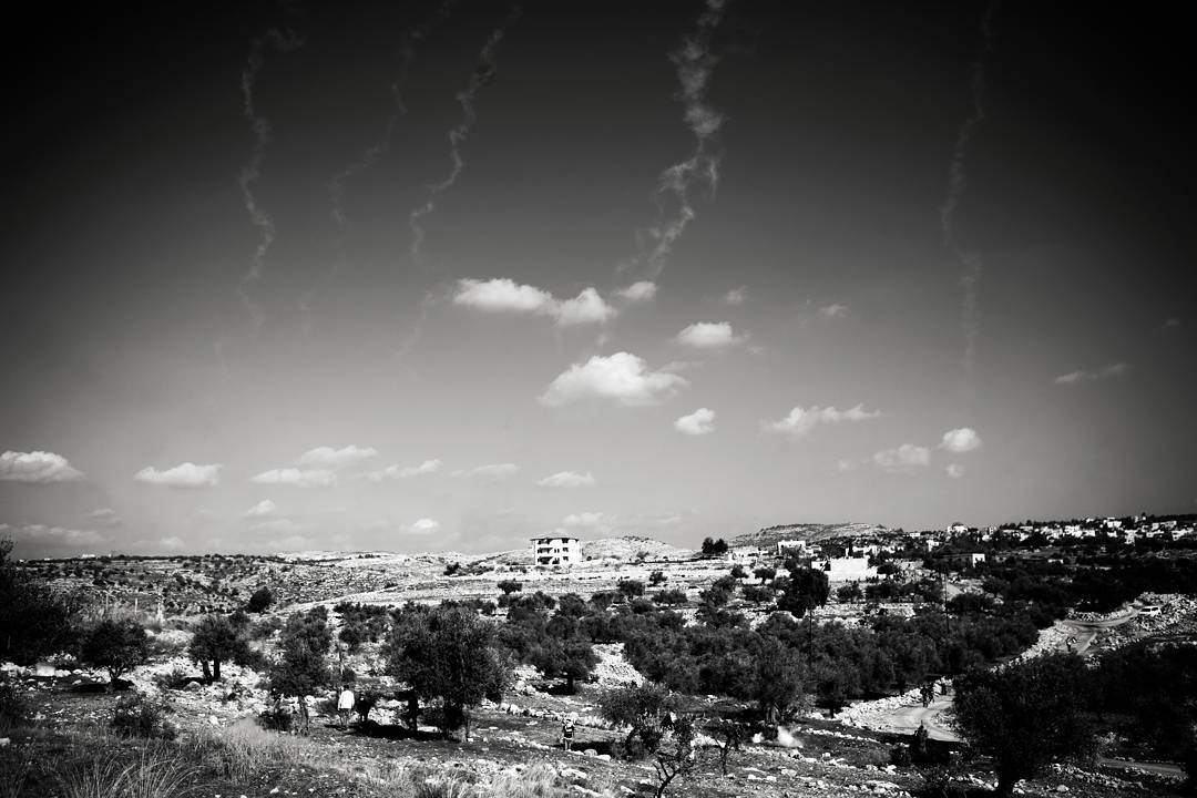 Tear gas trails down near the Palestinian town of Bil'in in the West Bank. Protestors, hiding behind trees, were throwin