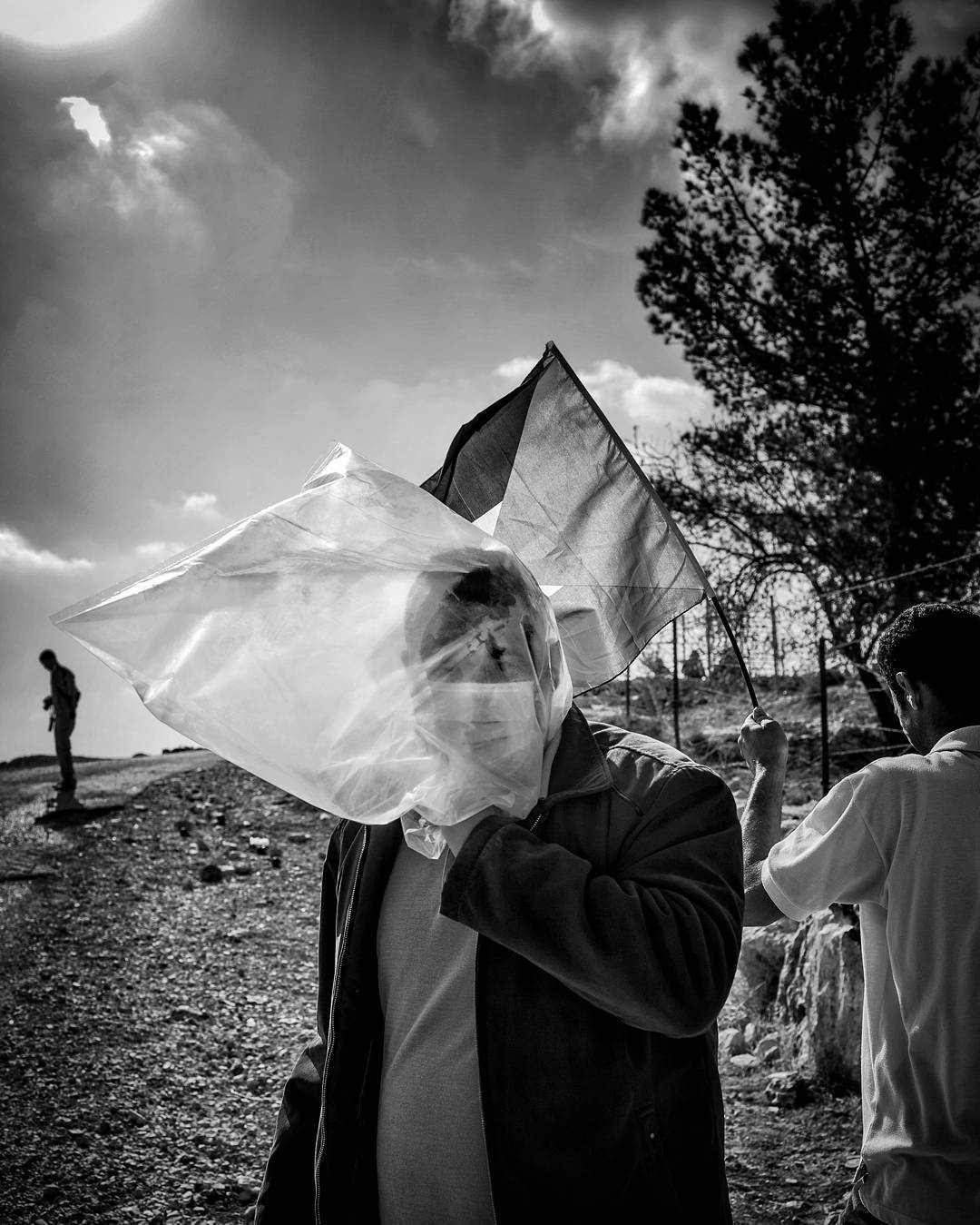 Using an improvised gas mask a protestor stands near the Palestinian town of Bil'in in the West Bank. Protestors were ha